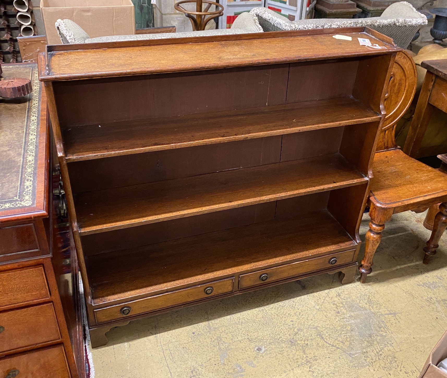 A 19th century slender mahogany graduated dwarf open bookcase, width 108cm, depth 26cm, height 99cm